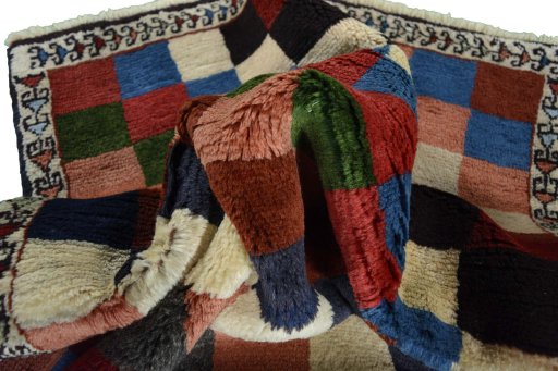 Corner detail of 2000s Persian Gabbeh rug showing border pattern and Wool pile