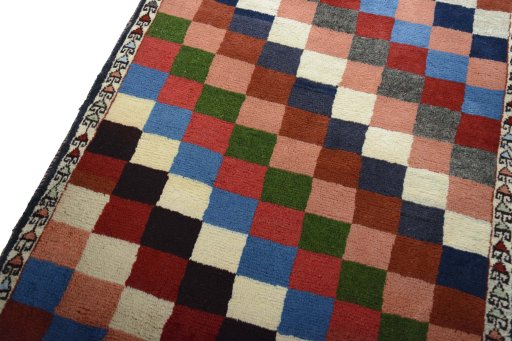 Backside of handmade 2000s Persian Gabbeh rug showing knot structure and weave density