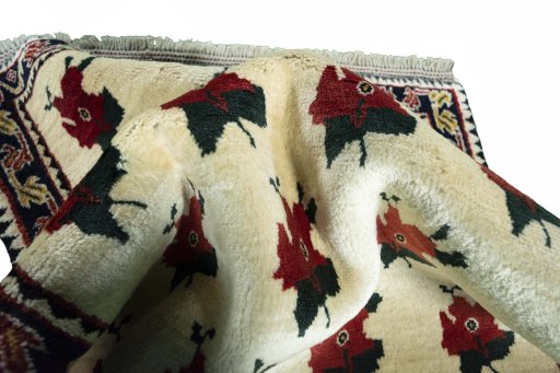 Corner detail of 2000s Persian Gabbeh rug showing border pattern and Wool pile