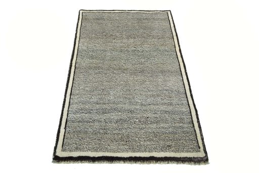 Surface texture of 2000s Persian Gabbeh rug with natural Wool and intricate pattern