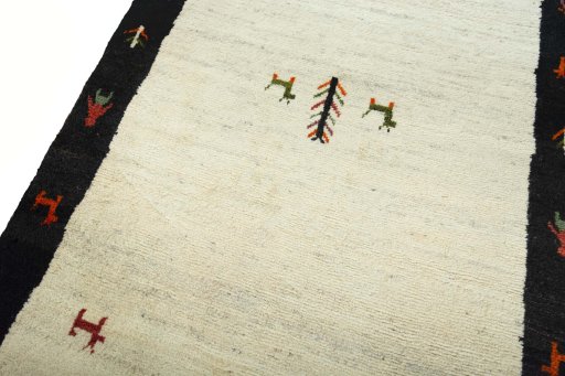 Backside of handmade 2000s Persian Gabbeh rug showing knot structure and weave density