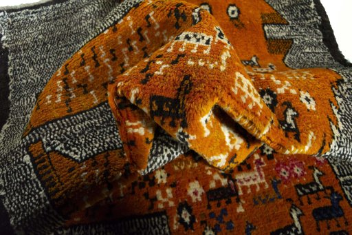 Corner detail of 2000s Persian Gabbeh rug showing border pattern and Wool pile