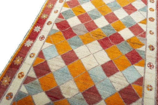 Backside of handmade 2000s Persian Gabbeh rug showing knot structure and weave density