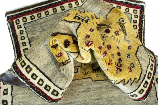 Corner detail of 2000s Persian Gabbeh rug showing border pattern and Wool pile