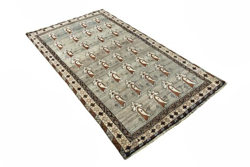 Corner detail of 2000s Persian Gabbeh rug showing border pattern and Wool pile
