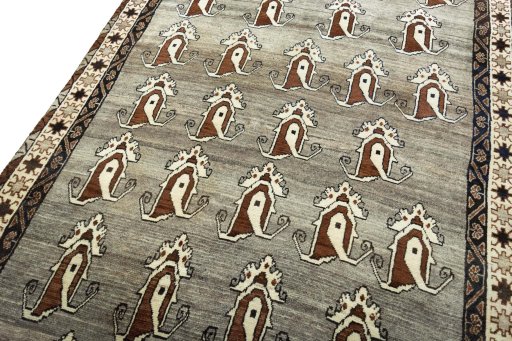 Surface texture of 2000s Persian Gabbeh rug with natural Wool and intricate pattern