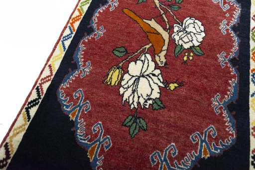 Backside of handmade 2000s Persian Gabbeh rug showing knot structure and weave density