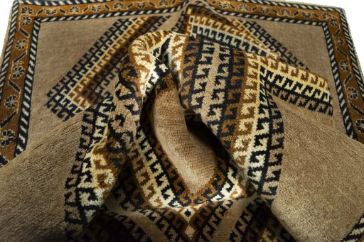 Corner detail of 2000s Persian Gabbeh rug showing border pattern and Wool pile
