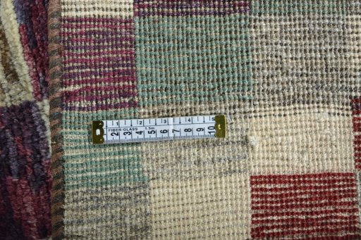 Corner detail of 2000s Persian Gabbeh rug showing border pattern and Wool pile