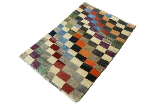 Corner detail of 2000s Persian Gabbeh rug showing border pattern and Wool pile