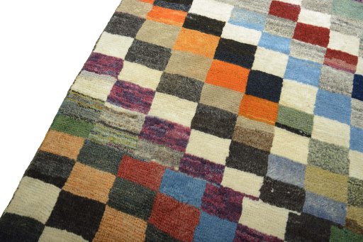 Backside of handmade 2000s Persian Gabbeh rug showing knot structure and weave density