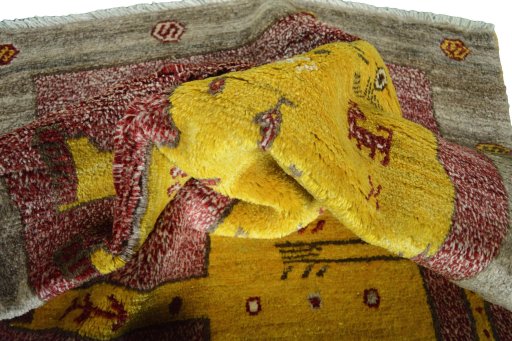 Corner detail of 2000s Persian Gabbeh rug showing border pattern and Wool pile