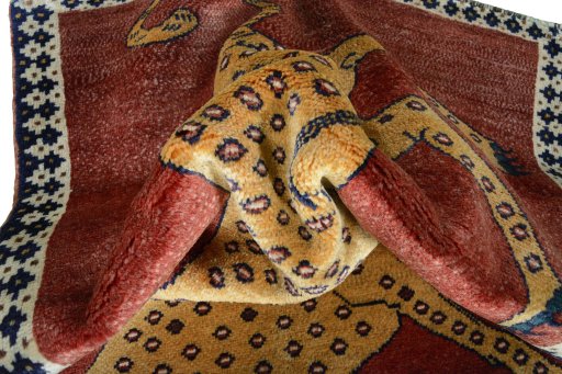 Corner detail of 2000s Persian Gabbeh rug showing border pattern and Wool pile