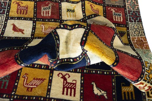 Corner detail of 2000s Persian Gabbeh rug showing border pattern and Wool pile