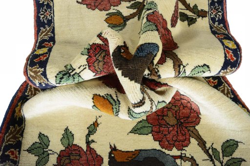 Corner detail of 2000s Persian Gabbeh rug showing border pattern and Wool pile