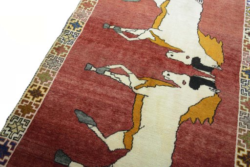 Backside of handmade 2000s Persian Gabbeh rug showing knot structure and weave density