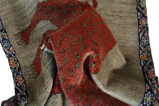 Corner detail of 2000s Persian Gabbeh rug showing border pattern and Wool pile