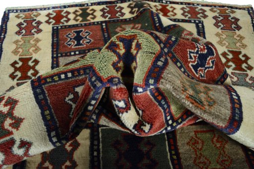 Corner detail of 2000s Persian Gabbeh rug showing border pattern and Wool pile