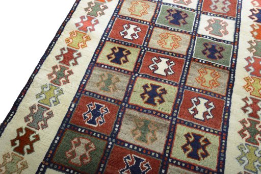 Backside of handmade 2000s Persian Gabbeh rug showing knot structure and weave density