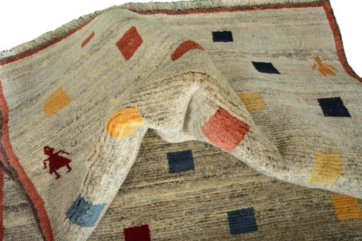 Corner detail of 2000s Persian Gabbeh rug showing border pattern and Wool pile