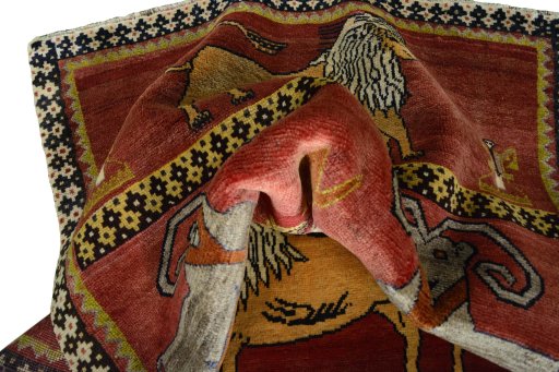 Corner detail of 2000s Persian Gabbeh rug showing border pattern and Wool pile