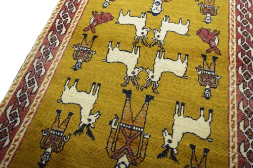 Backside of handmade 2000s Persian Gabbeh rug showing knot structure and weave density