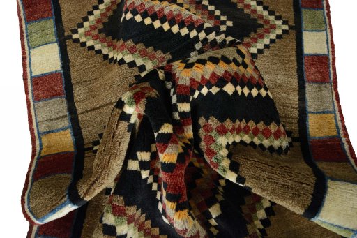 Corner detail of 2000s Persian Gabbeh rug showing border pattern and Wool pile