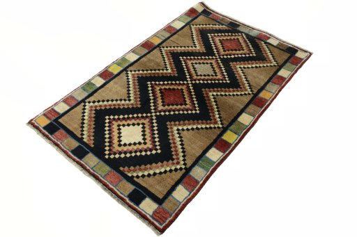 Corner detail of 2000s Persian Gabbeh rug showing border pattern and Wool pile