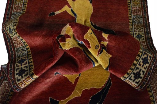 Corner detail of 2000s Persian Gabbeh rug showing border pattern and Wool pile