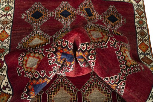 Corner detail of 2000s Persian Gabbeh rug showing border pattern and Wool pile