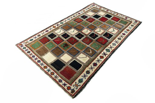 Corner detail of 2000s Persian Gabbeh rug showing border pattern and Wool pile
