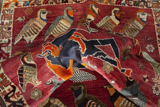 Corner detail of 2000s Persian Gabbeh rug showing border pattern and Wool pile
