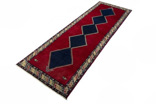 Corner detail of 2000s Persian Gabbeh rug showing border pattern and Wool pile