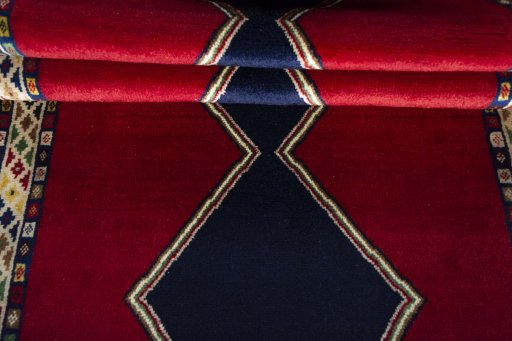 Full view of 2000s Persian Gabbeh rug from Iran / Persia, 307 × 102 cm in Red tones