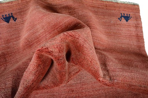 Corner detail of 2000s Persian Gabbeh rug showing border pattern and Wool pile