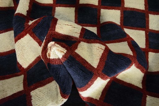 Corner detail of 2000s Persian Gabbeh rug showing border pattern and Wool pile