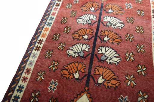 Backside of handmade 2000s Persian Gabbeh rug showing knot structure and weave density