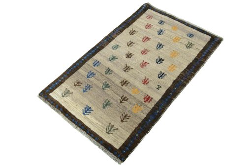 Corner detail of 2000s Persian Gabbeh rug showing border pattern and Wool pile