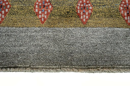 Backside of handmade 2000s Persian Gabbeh rug showing knot structure and weave density
