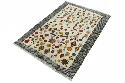 Corner detail of 2000s Persian Gabbeh rug showing border pattern and Wool pile