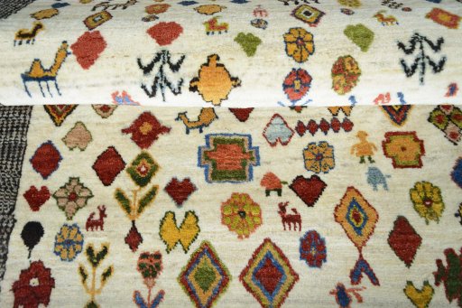 Full view of 2000s Persian Gabbeh rug from Iran / Persia, 144 × 100 cm in Beige tones