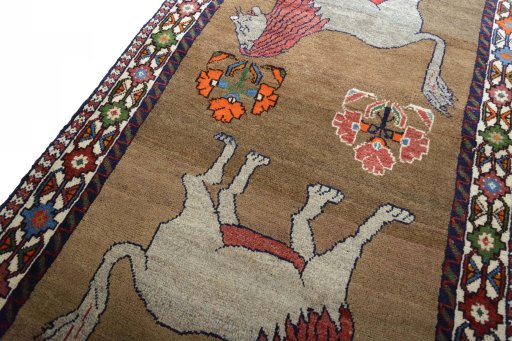 Backside of handmade 2000s Persian Gabbeh rug showing knot structure and weave density