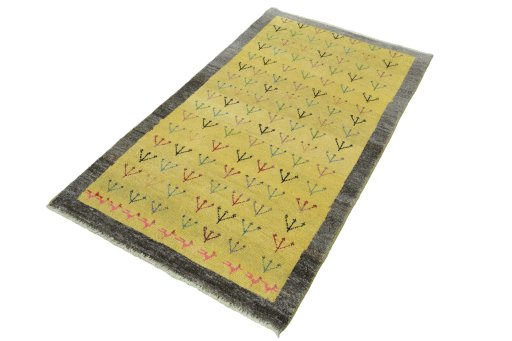 Corner detail of 2000s Persian Gabbeh rug showing border pattern and Wool pile