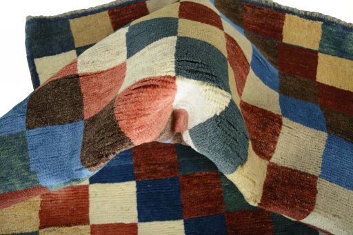 Corner detail of 2000s Persian Gabbeh rug showing border pattern and Wool pile