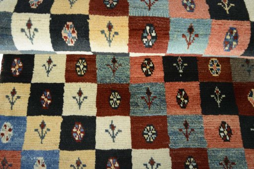 Full view of 2000s Persian Gabbeh rug from Iran / Persia, 181 × 81 cm in Multi Color tones