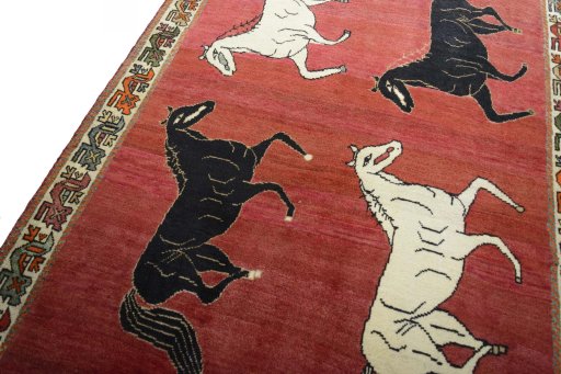 Backside of handmade 2000s Persian Gabbeh rug showing knot structure and weave density