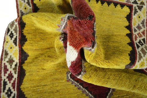 Corner detail of 2000s Persian Gabbeh rug showing border pattern and Wool pile