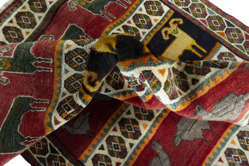 Corner detail of 2000s Persian Gabbeh rug showing border pattern and Wool pile