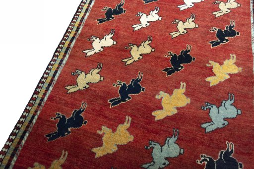 Backside of handmade 2000s Persian Gabbeh rug showing knot structure and weave density