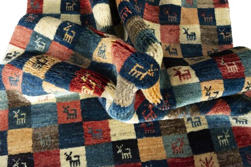 Corner detail of 2000s Persian Gabbeh rug showing border pattern and Wool pile